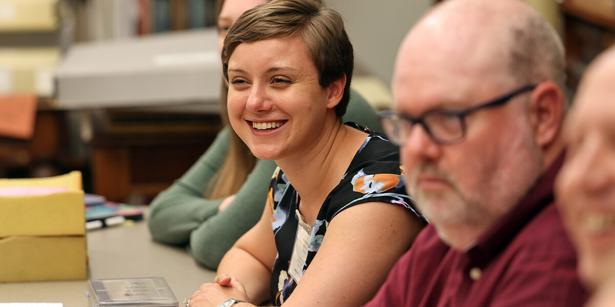 Student smiling while sitting in class with classmates
