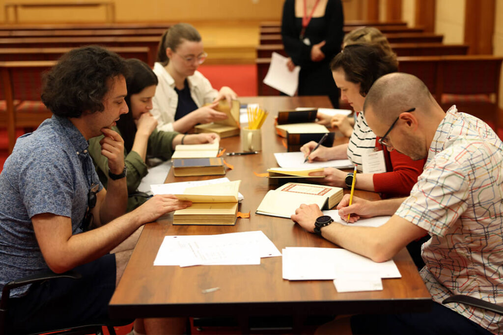 Group of people cataloging books