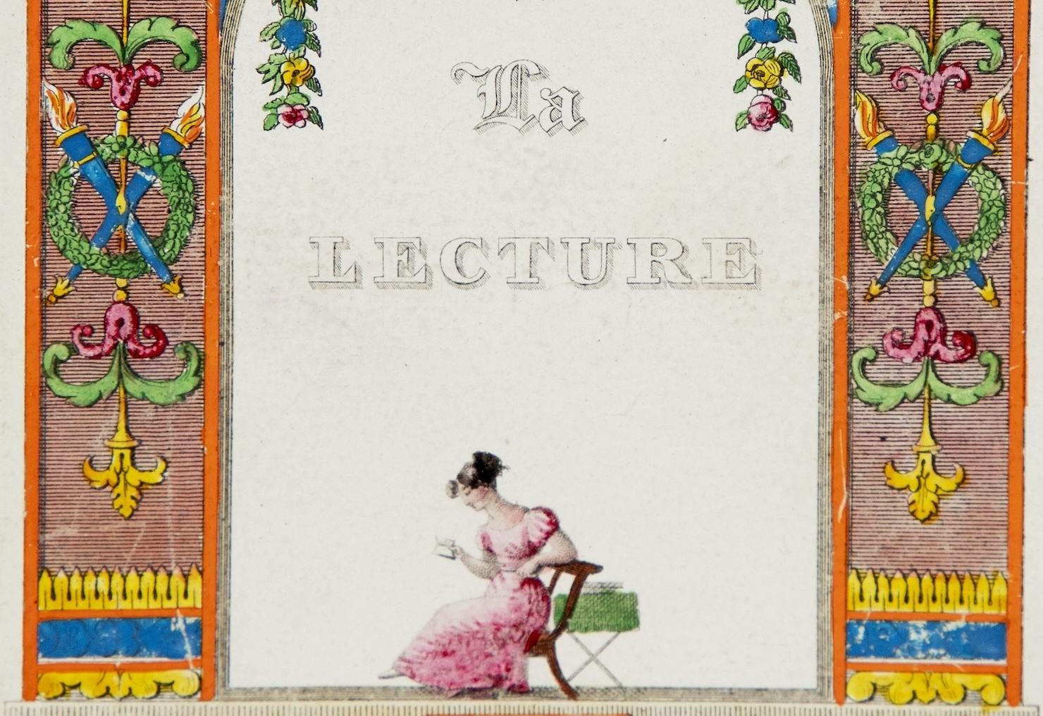 Detail of a book cover with a decorative frame in orange, blue, green, and pink with floral motifs, crossed torches, and other decorative designs. This surrounds a plain pale center against which are the words "La Lecture" and a small drawing of a woman in a pink Regency-era dress seated at a green-draped side table while she reads a small book.